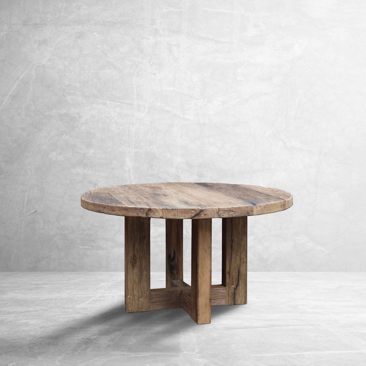 ROTO Foundry Axis Reclaimed Oak Round Table in a stone room