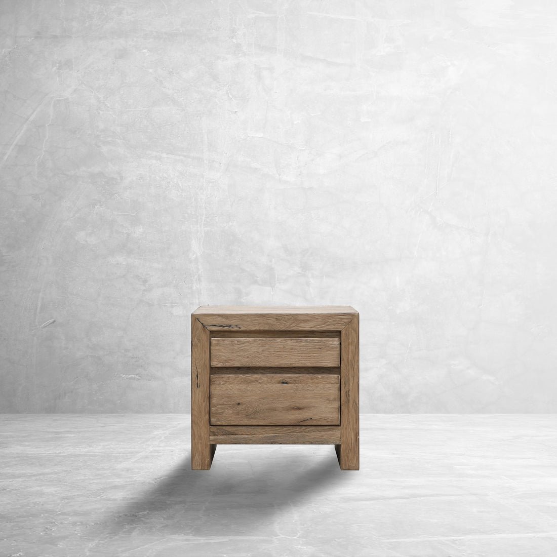 The ROTO Foundry DOK Reclaimed Oak Nightstand in a stone room